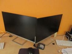 Three HP flatscreen monitors
