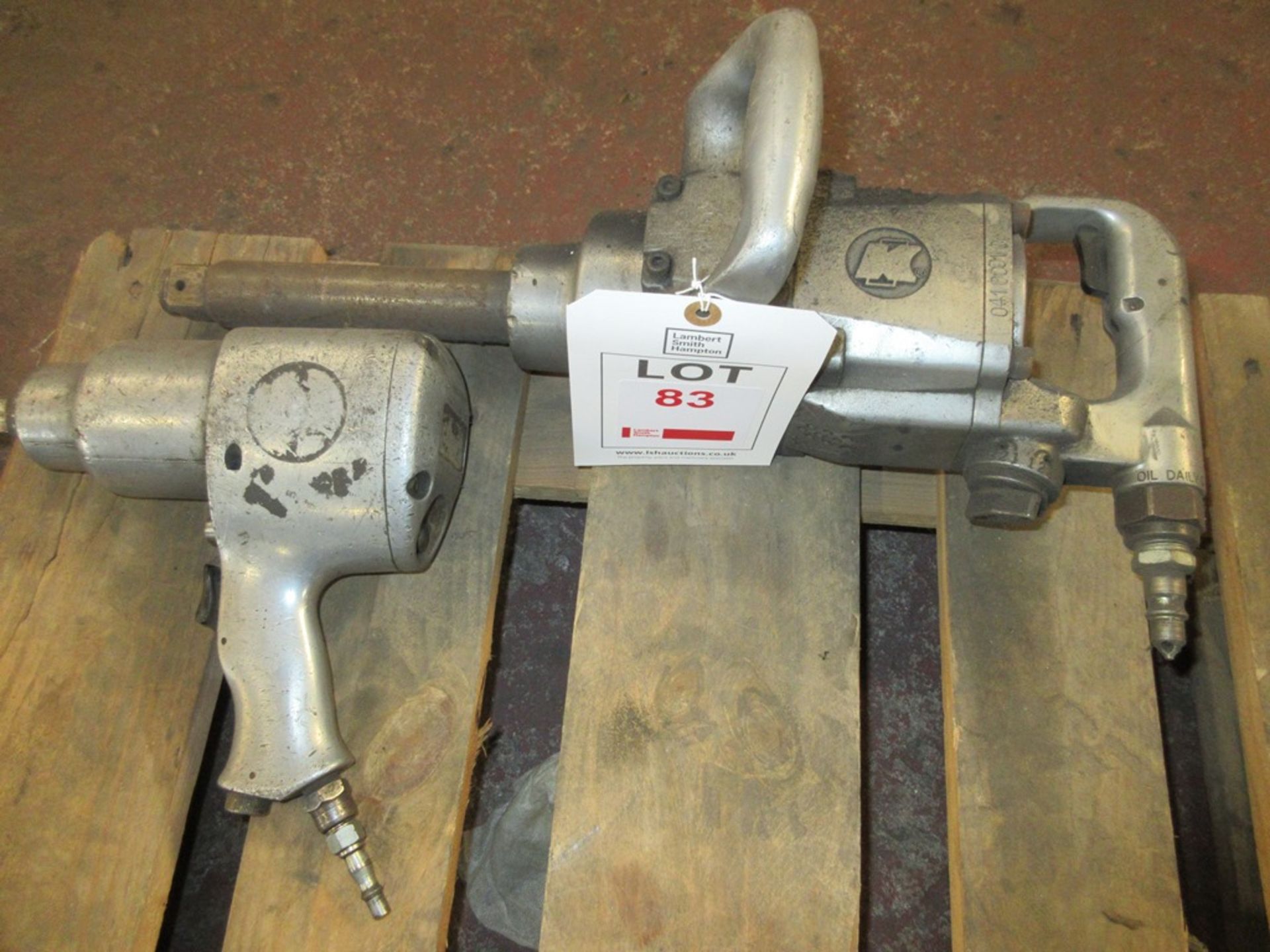 Two pneumatic impact wrenches
