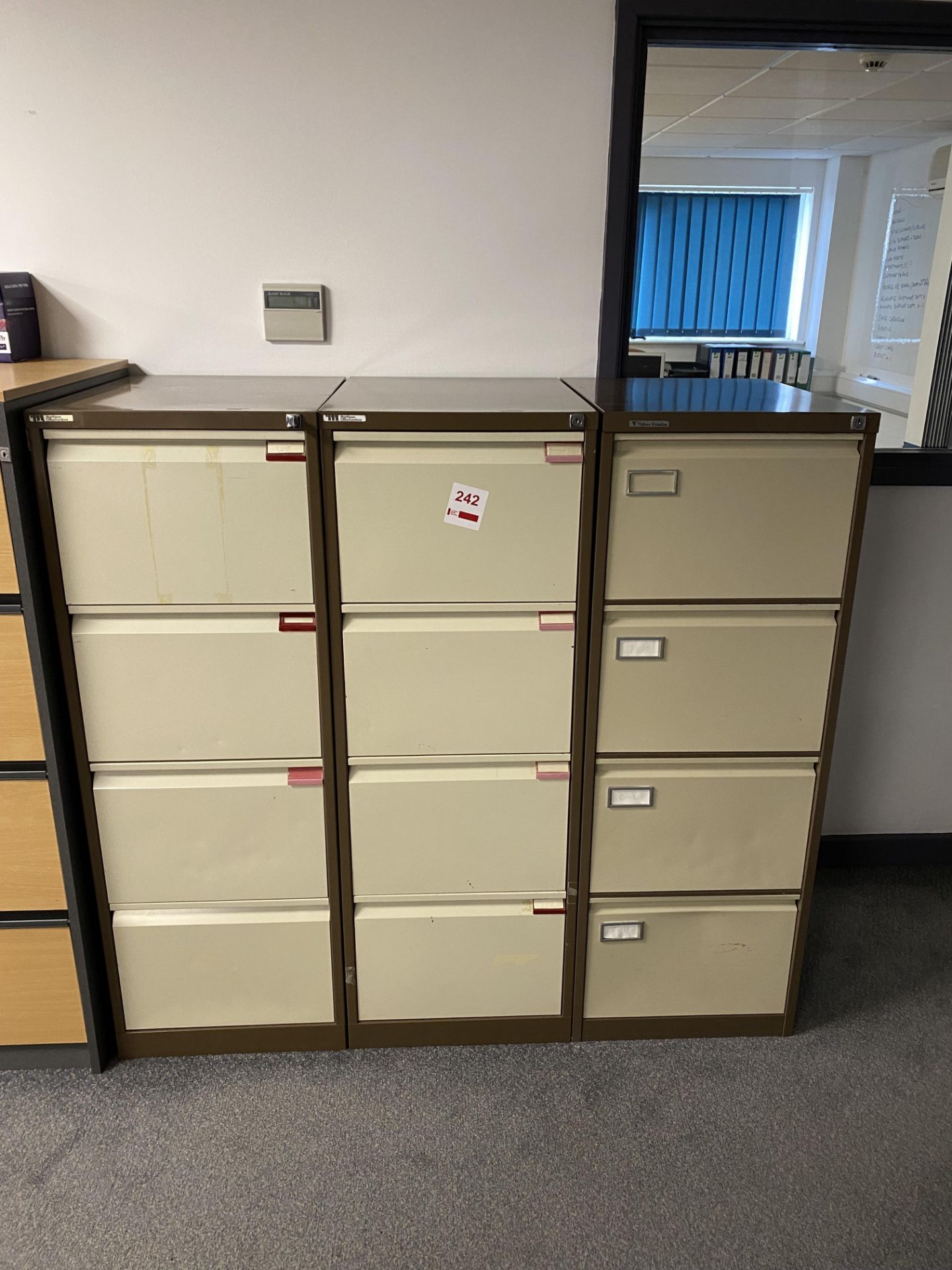 Three 4-drawer metal filing cabinets