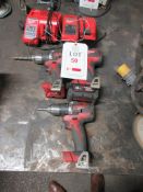 Three Milwaukee cordless drills, two chargers, one battery