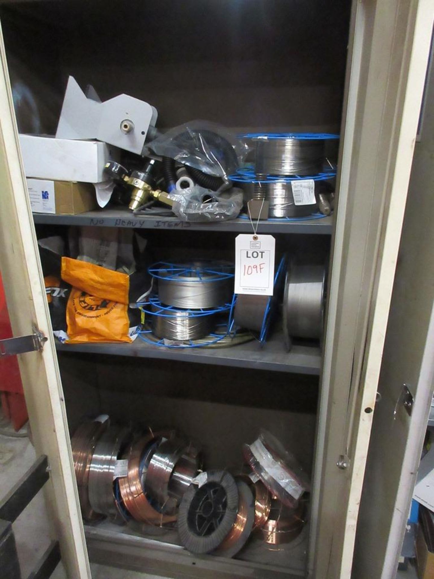 Cupboards and contents including assorted welding wire, regulators, etc.