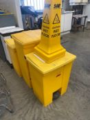 Three yellow chemical waste bins and two yellow wet floor caution bollards