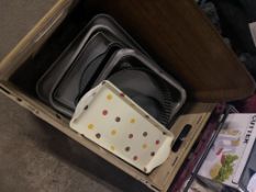 Two boxes of kitchenware to include cheese wire, trays, chopper and baking tins