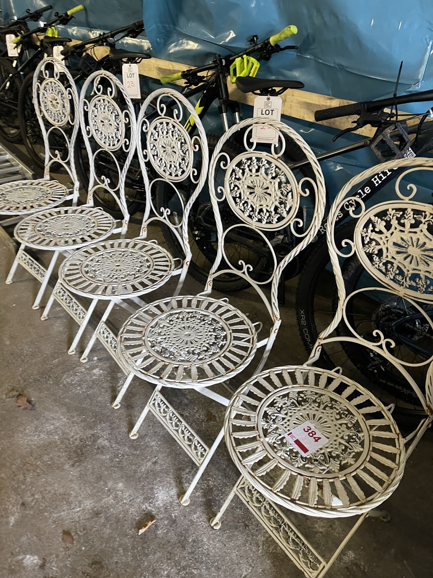 Five metal chairs and three oval matching tables