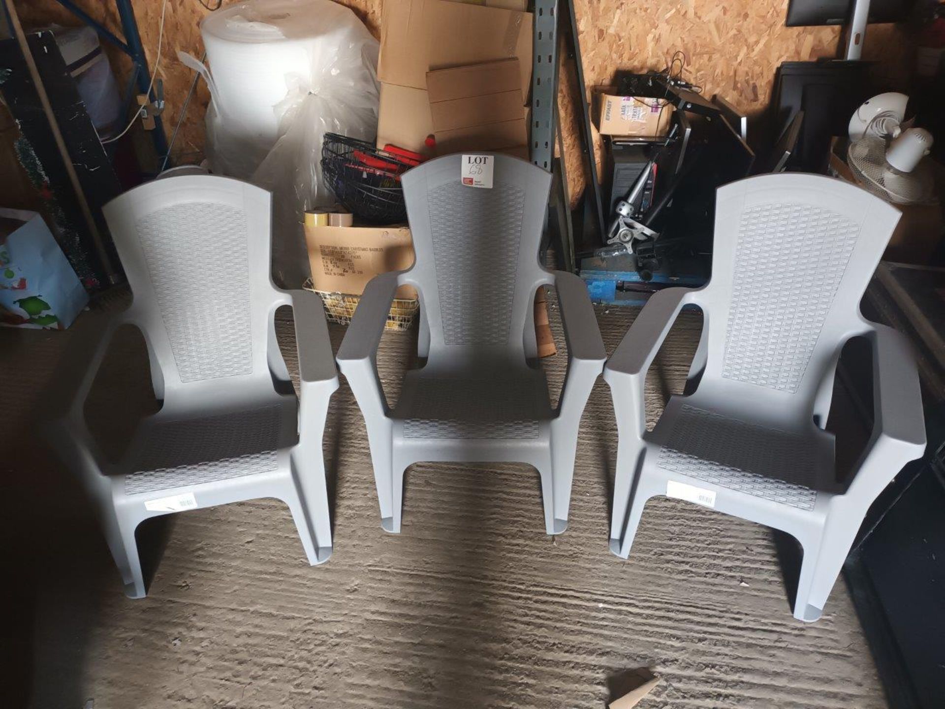 Three grey plastic stackable chairs