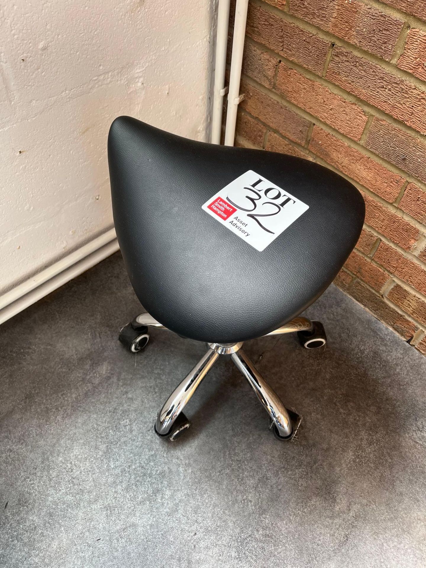 Black leatherette mobile stool with chrome base