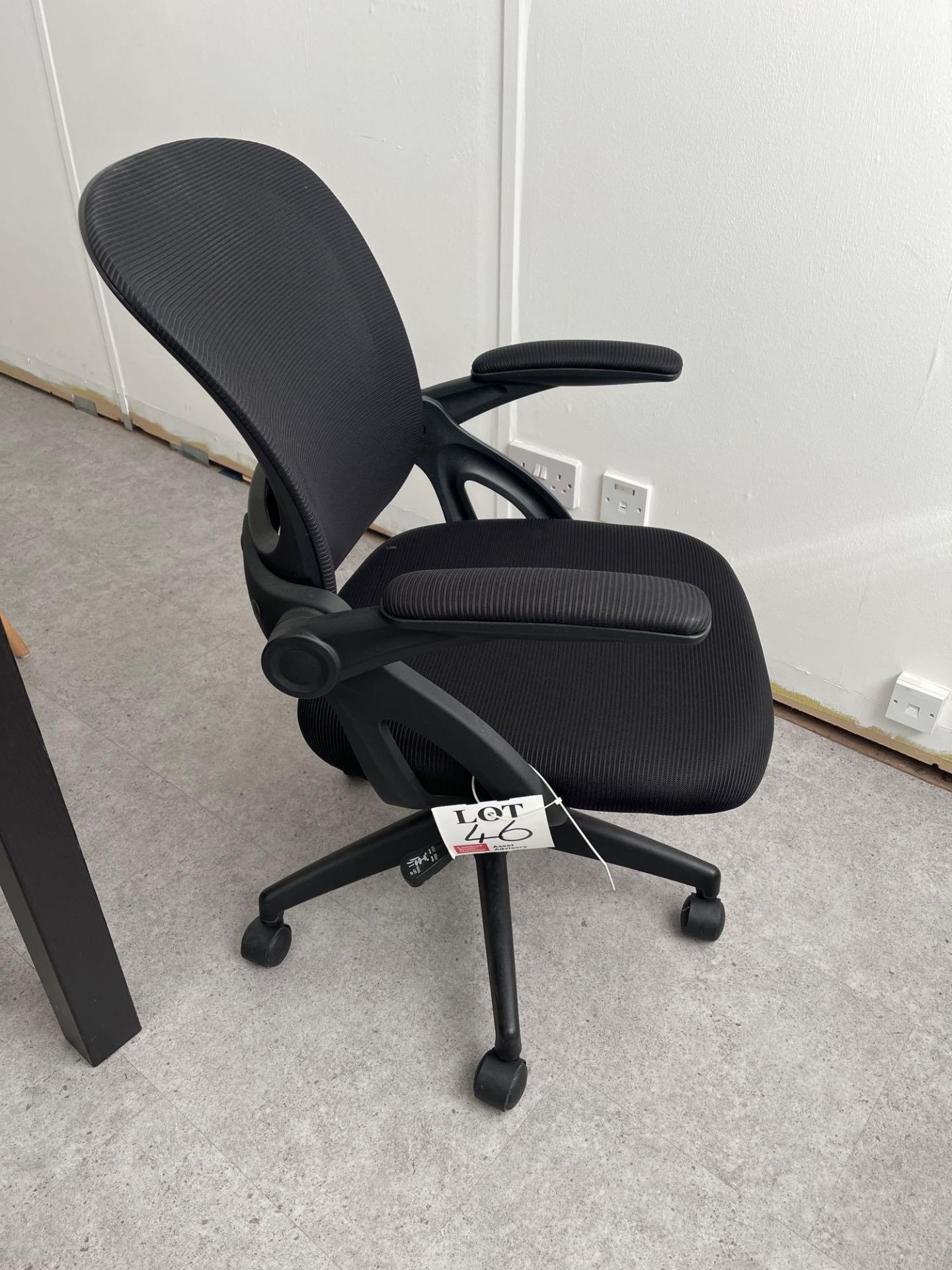 Two black mesh back swivel office chairs
