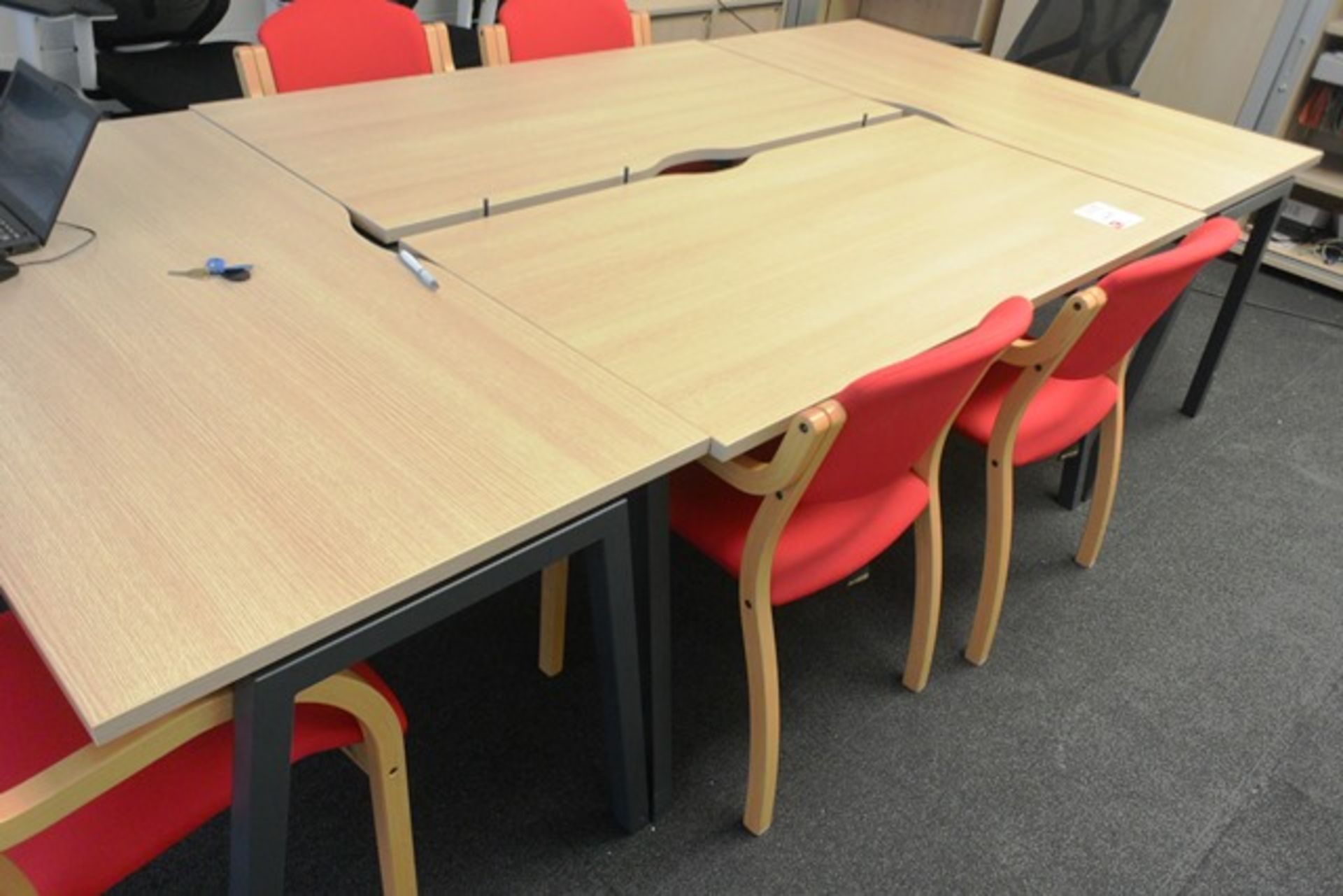 Light oak effect rectangular 4 section boardroom table and six red cloth upholsterd chairs