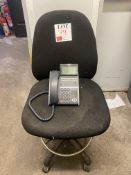 NEC desktop phone and a black upholstered office chair