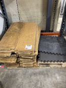 Pallet of various wooden planks and foam floor matting