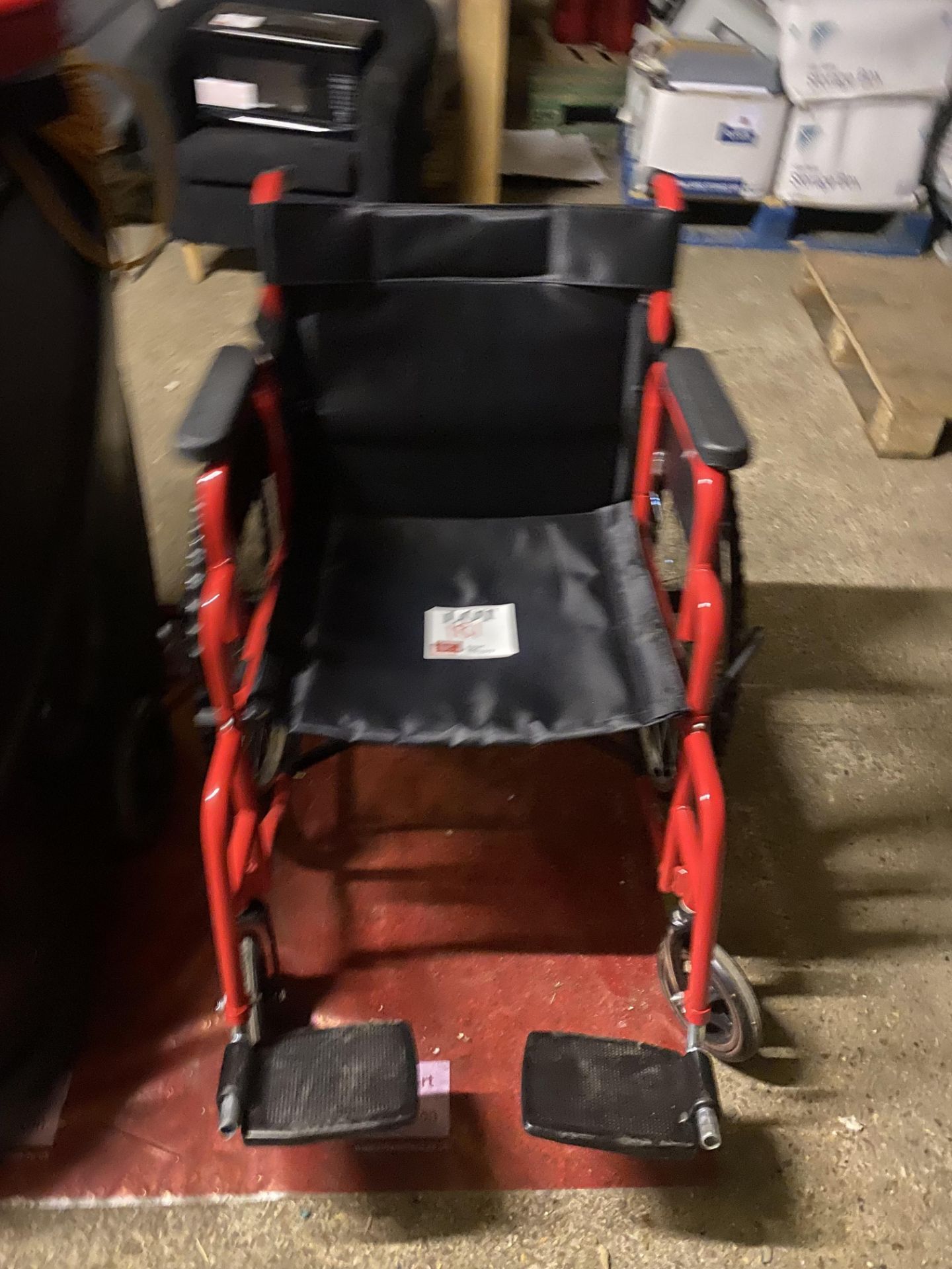 Red metal framed adult wheelchair