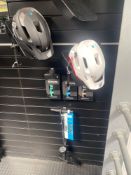 Two cycle helmets, three sets of pedals and a cycle hand pump