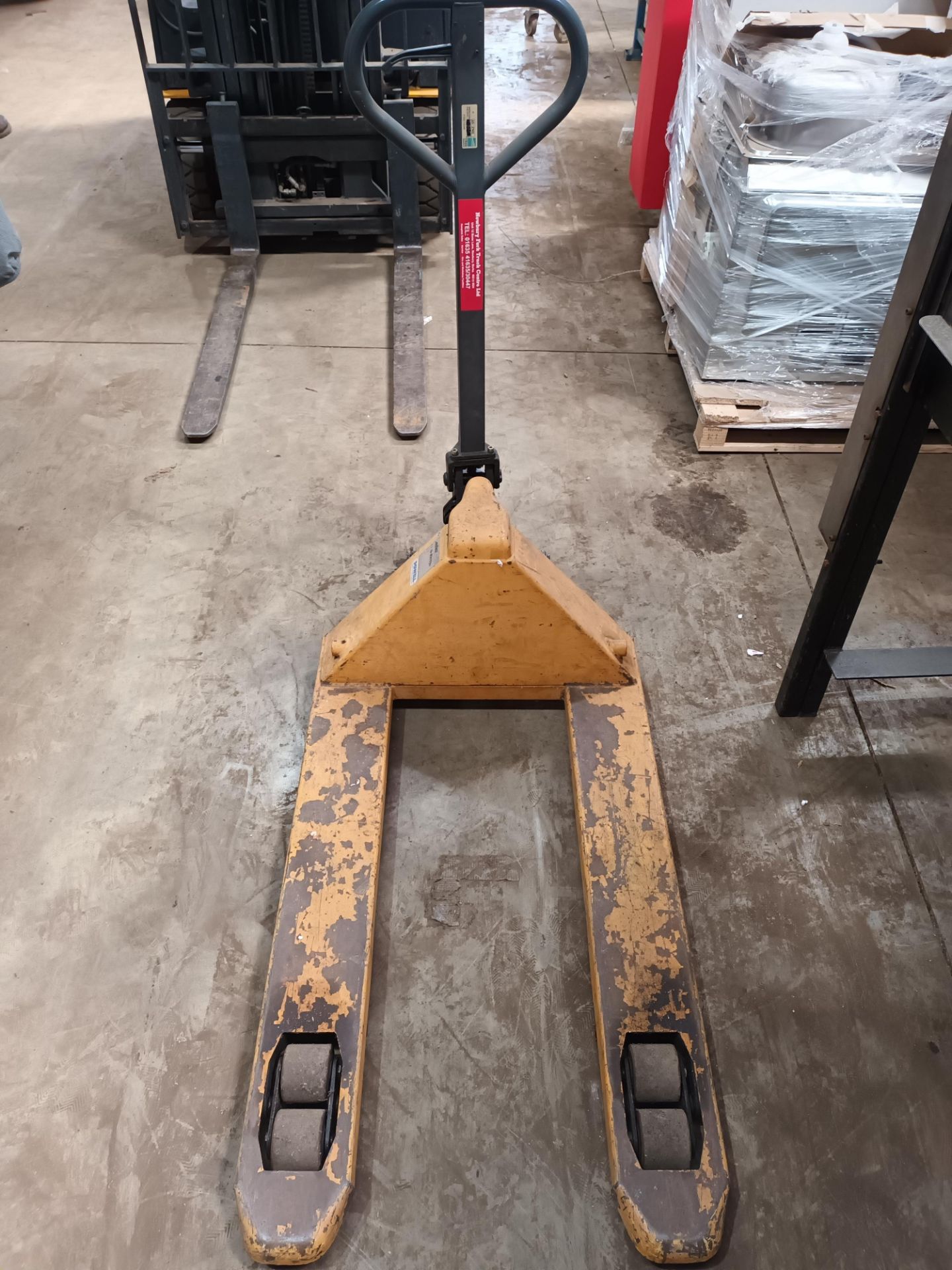 Powell MIC pallet truck, three various sack barrows and a set of steps (Located: Hanslope)
