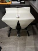 Two cream leather effect stools