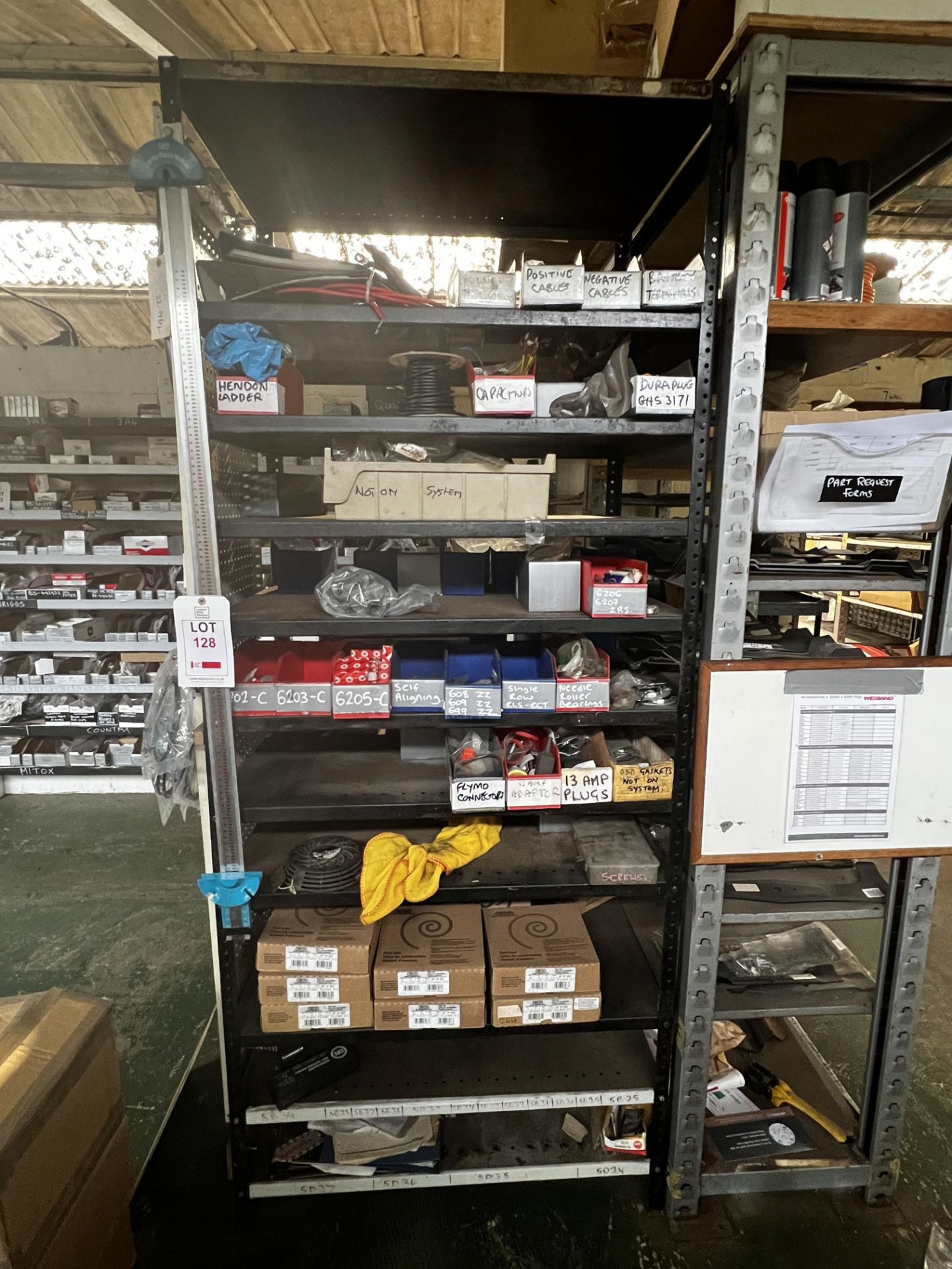 Rack including contents of fuel lines, 2-stroke, engine parts, cables, connectors etc. (this lot