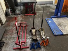 Lifting equipment to include red manual lift, two trolley jacks, two sets axle stands