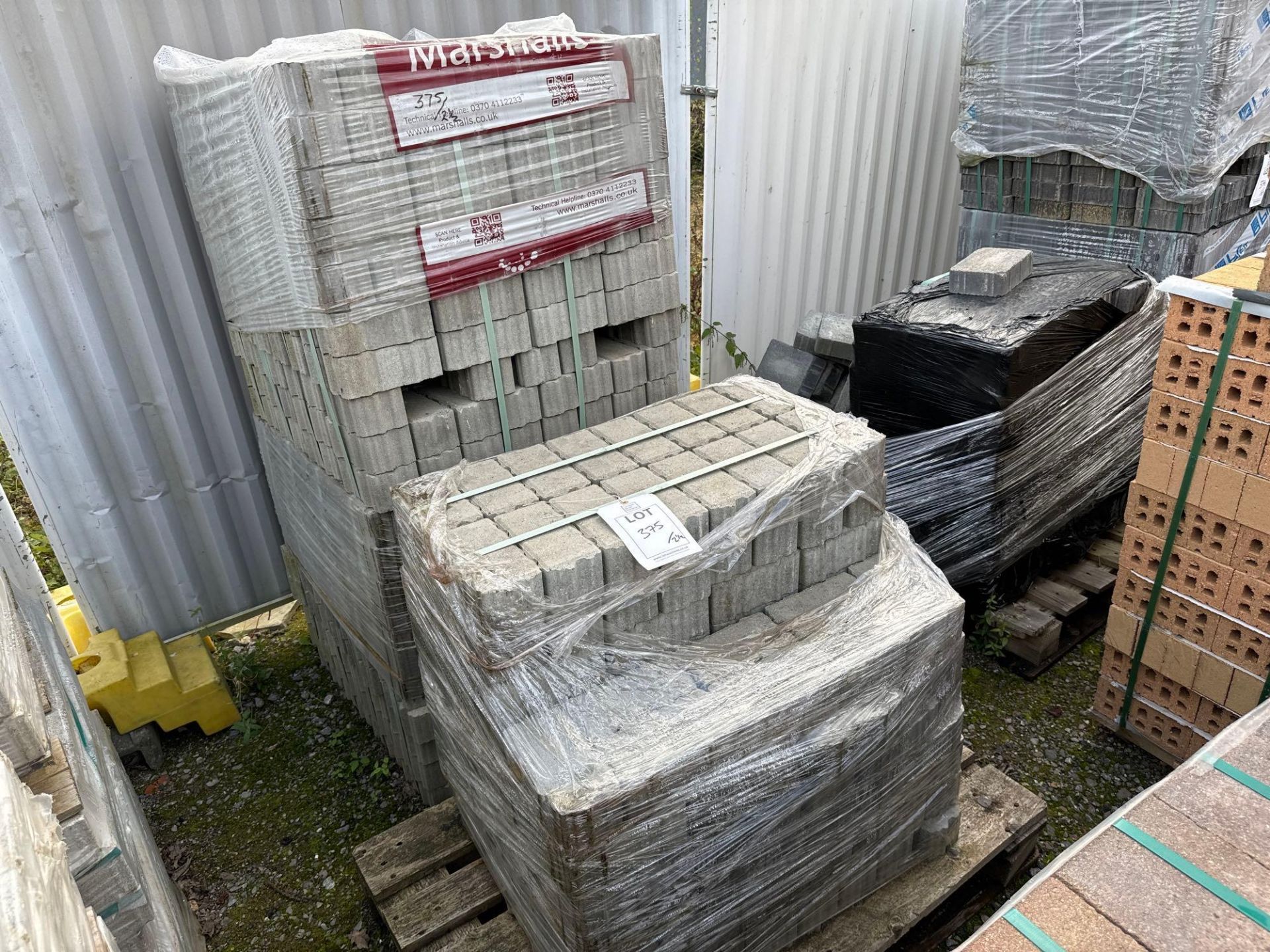 Two and a half pallets of grey permeable paving bricks