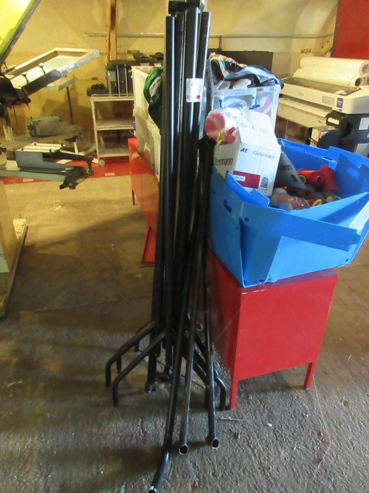 Two dismantled metal frame clothes racks