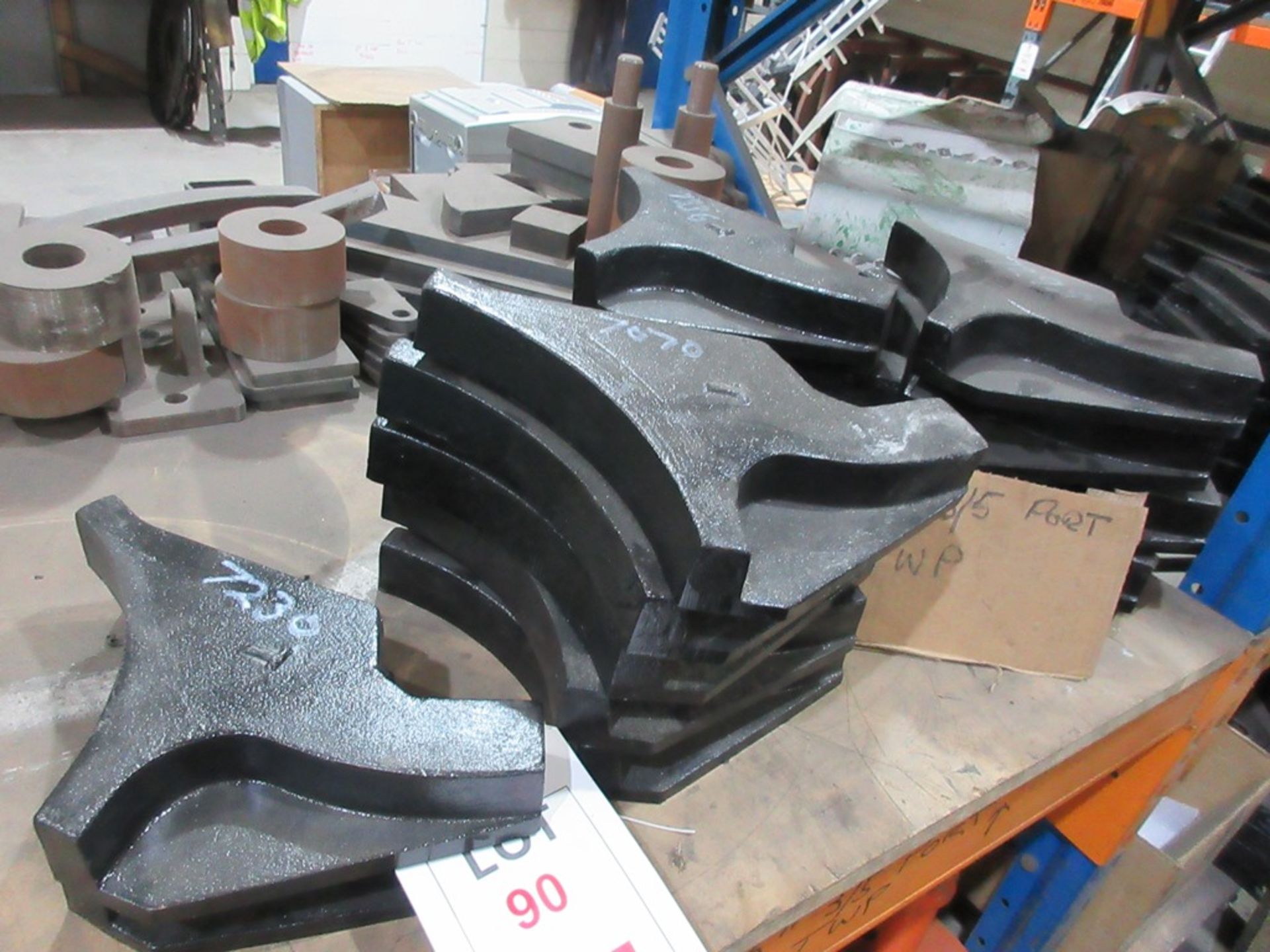 Four shelves of assorted top and bottom steel wear plates