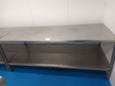 Two stainless steel preparation tables (approximately 8' x 2')