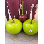 Two plastic apple displays, one cherry