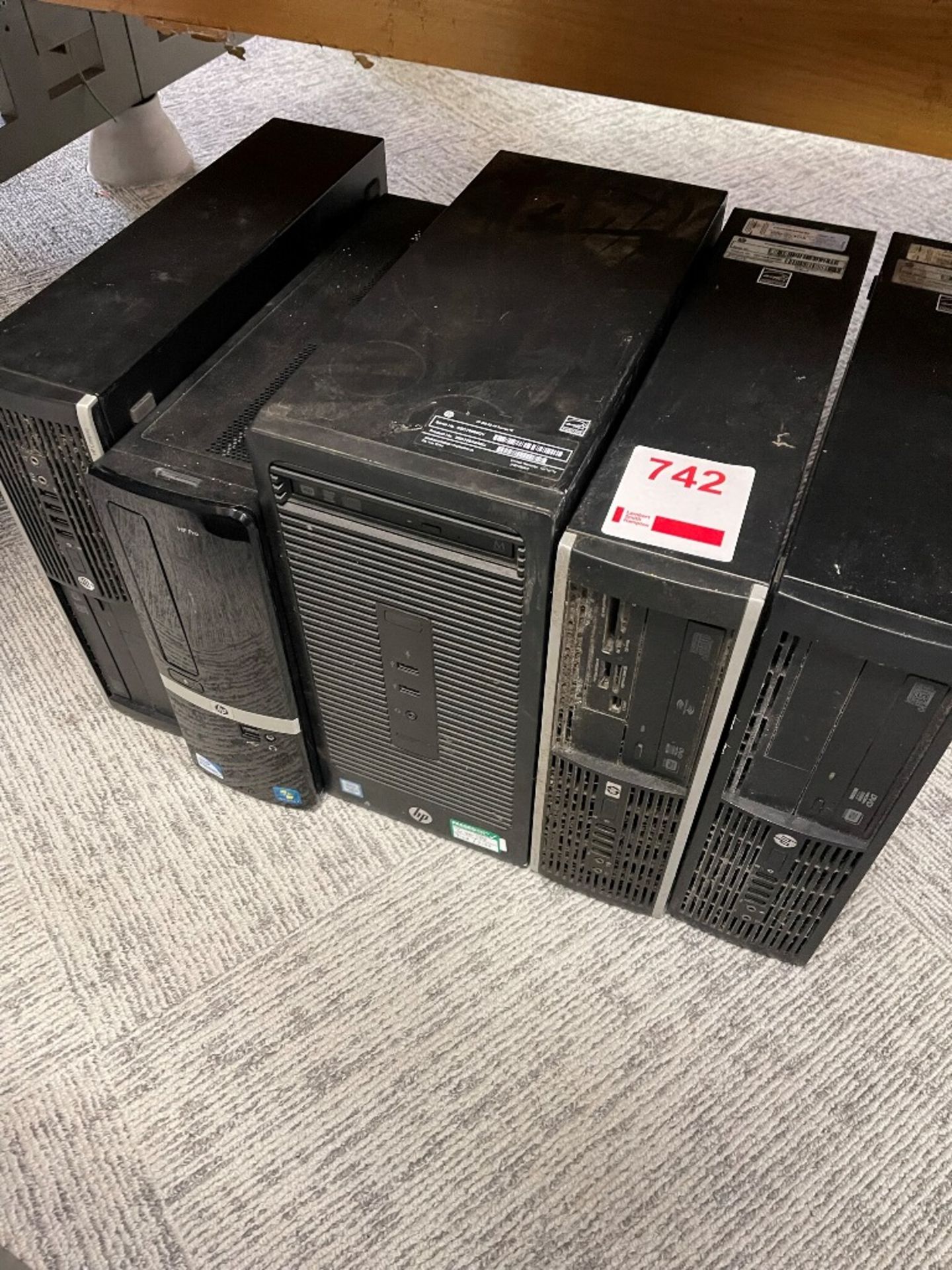 Five various HP computer towers, five keyboards