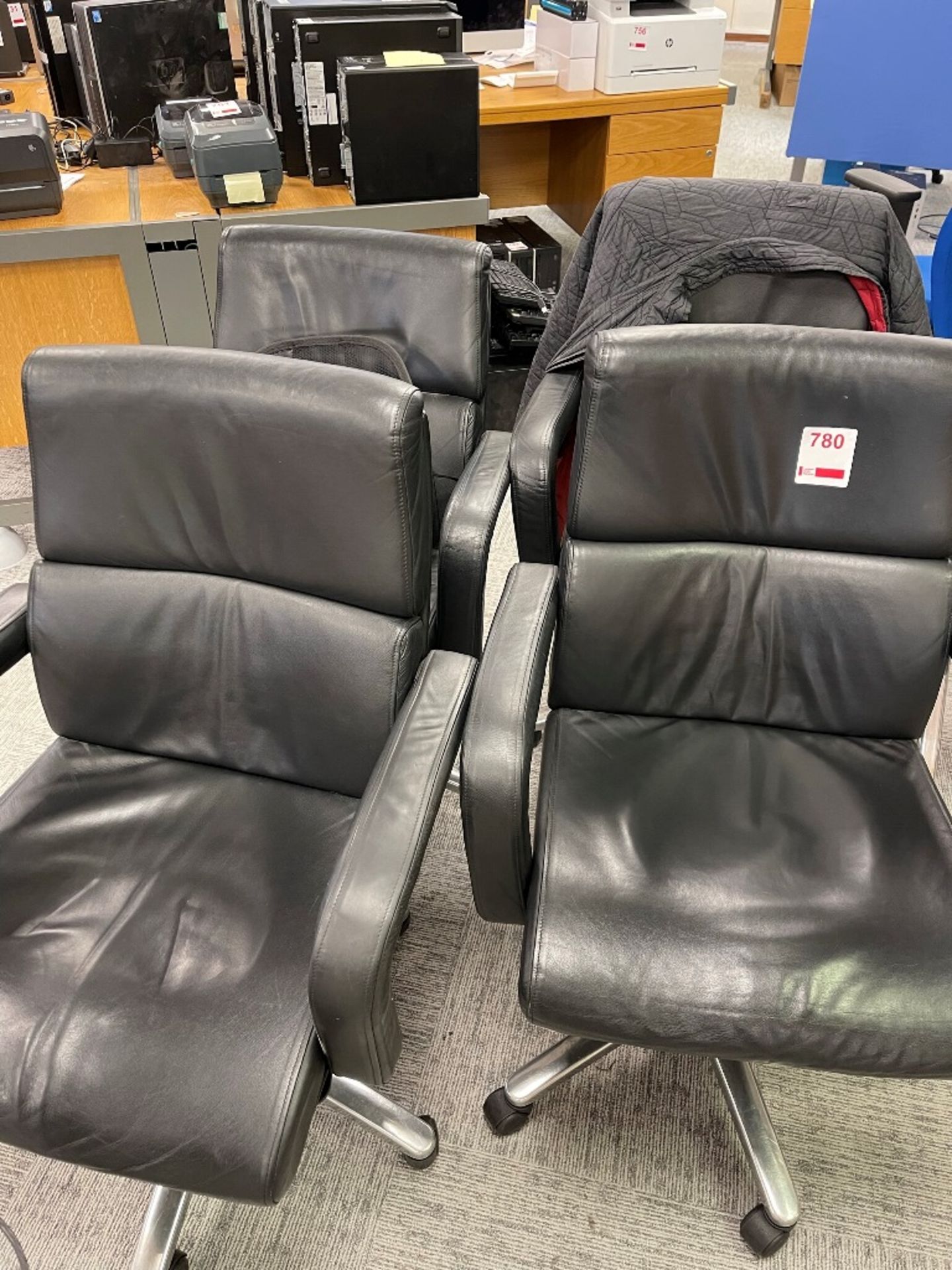 Four leatherette swivel manager's armchairs