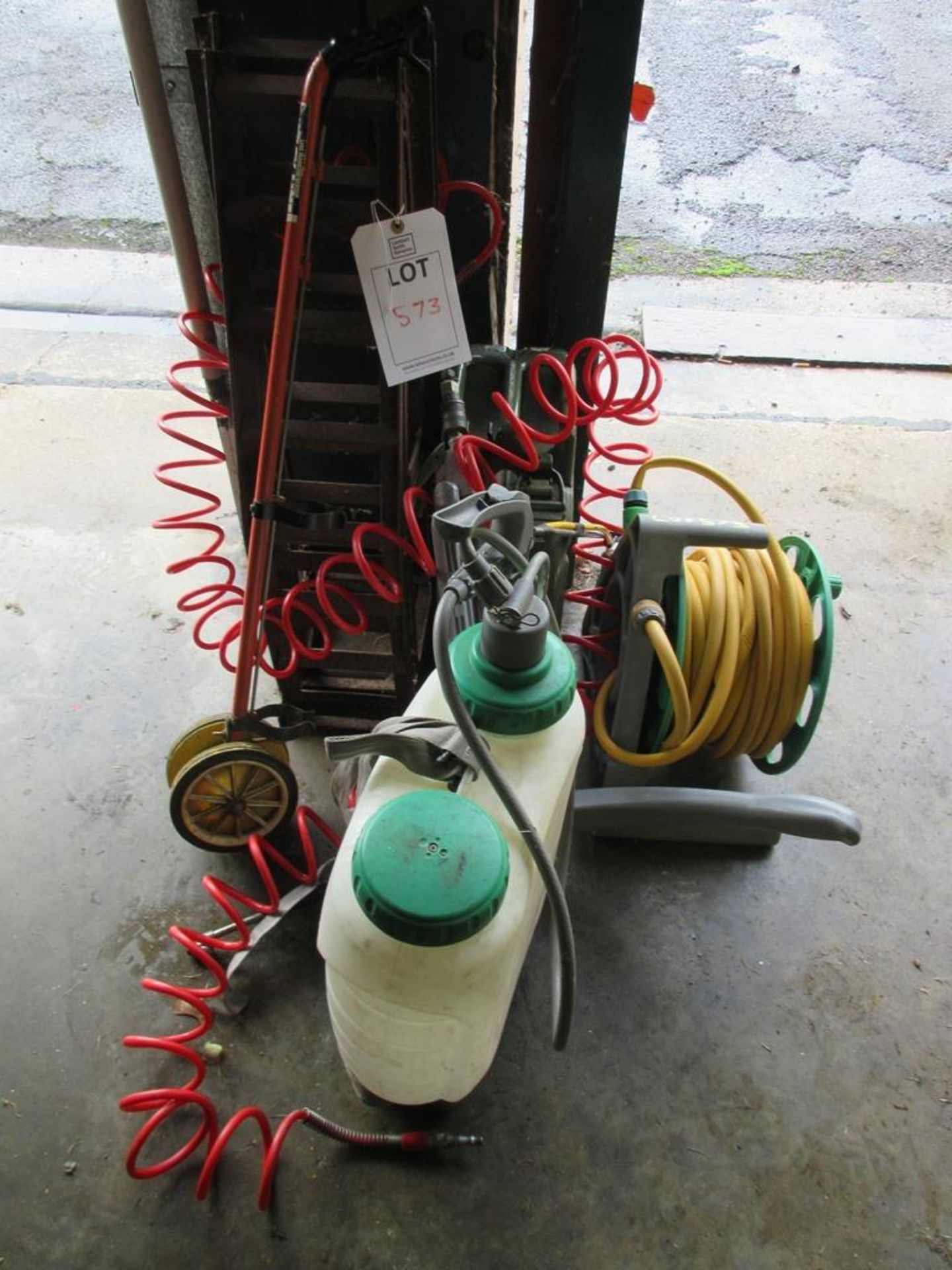 Miscellaneous lot including reeled hose pipe, car ramps, jerry can, wheelbarrow, tyre inflator, weed