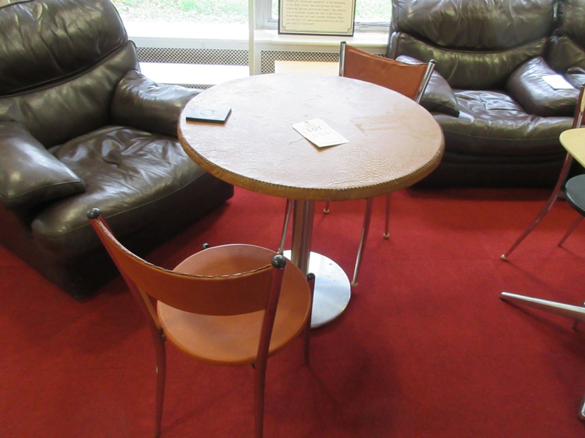 Two leather topped tables and four leather chairs