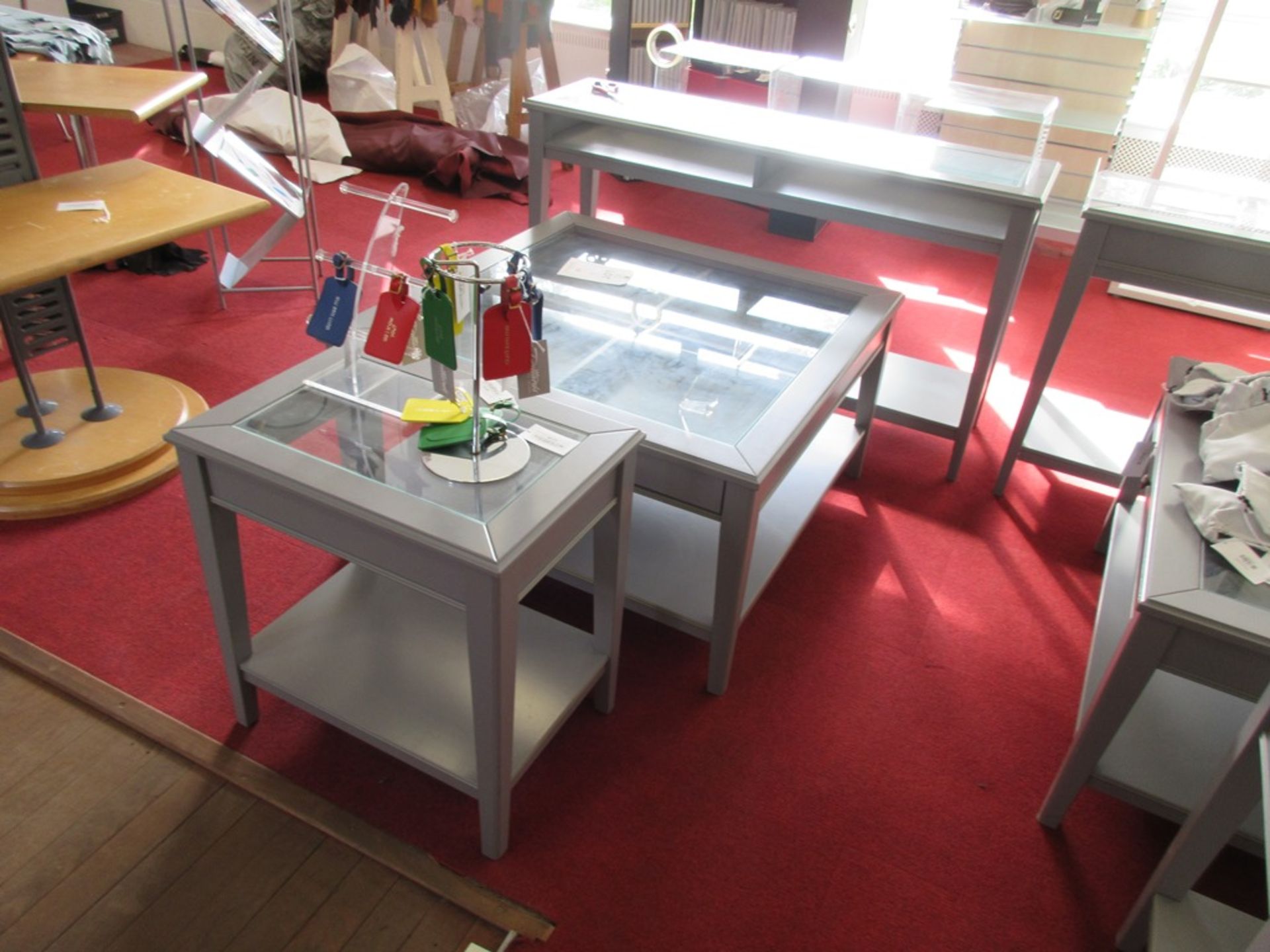 Three grey glazed topped display tables, 1 x 930 x 930 x 520mm, 1 x 580 x 400 x 600mm, 1 x 1320 x
