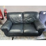 Leather upholstered two seater sofa, wood framed lounge chair with cushion and misty glass top recta