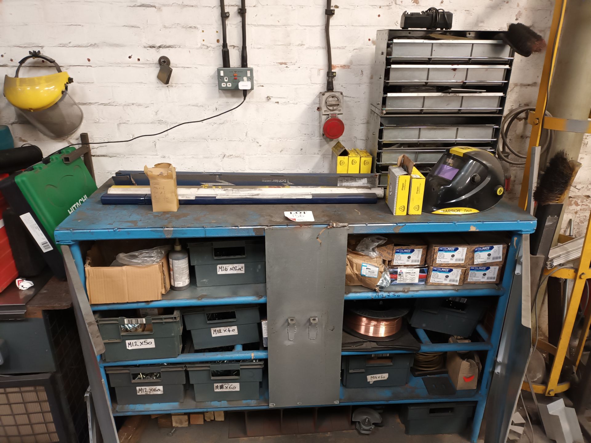 Metal workbench and contents to include various nuts, bolts and copper wire (as lotted)
