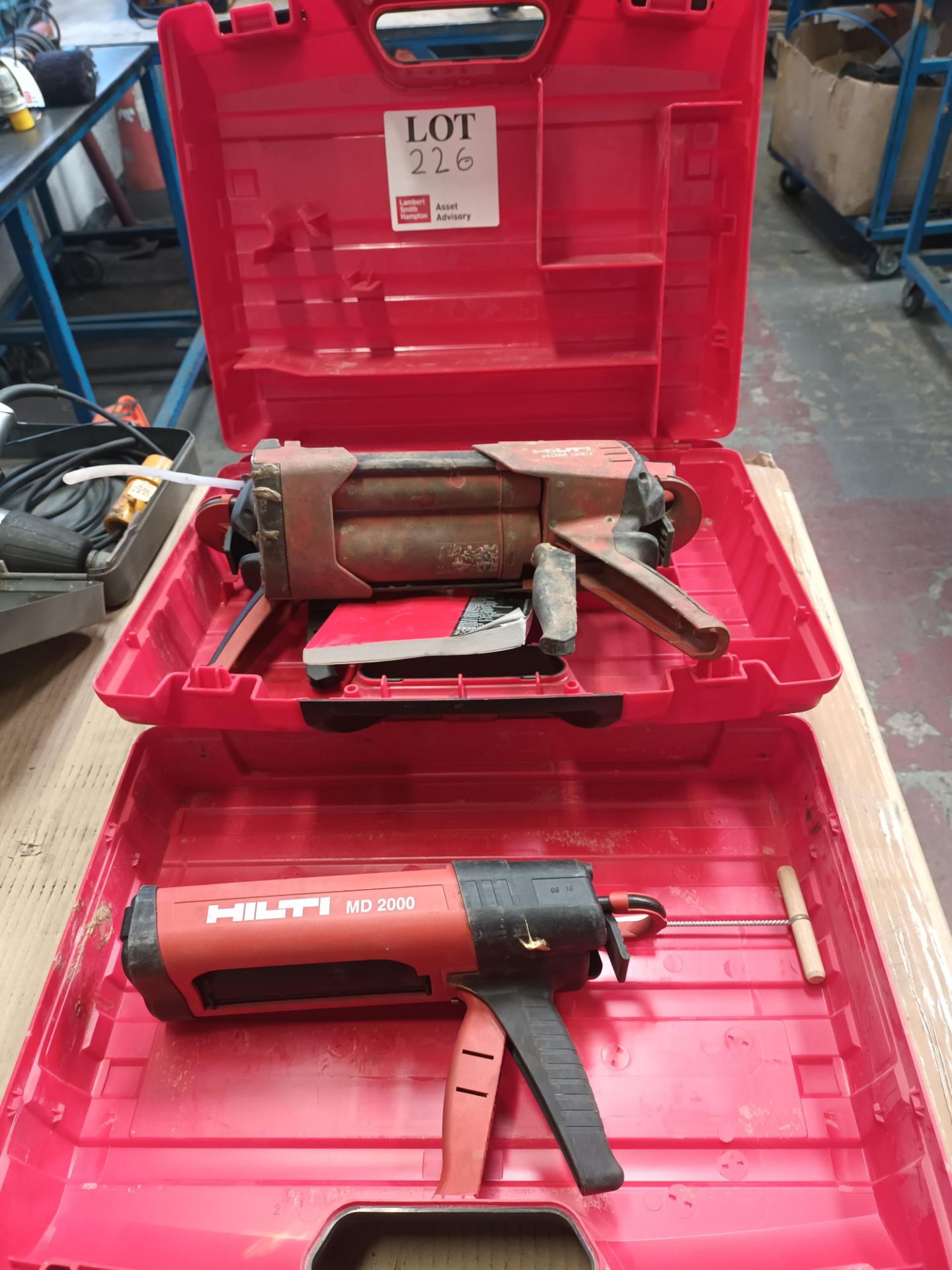 Two Hilti glue guns with carry cases