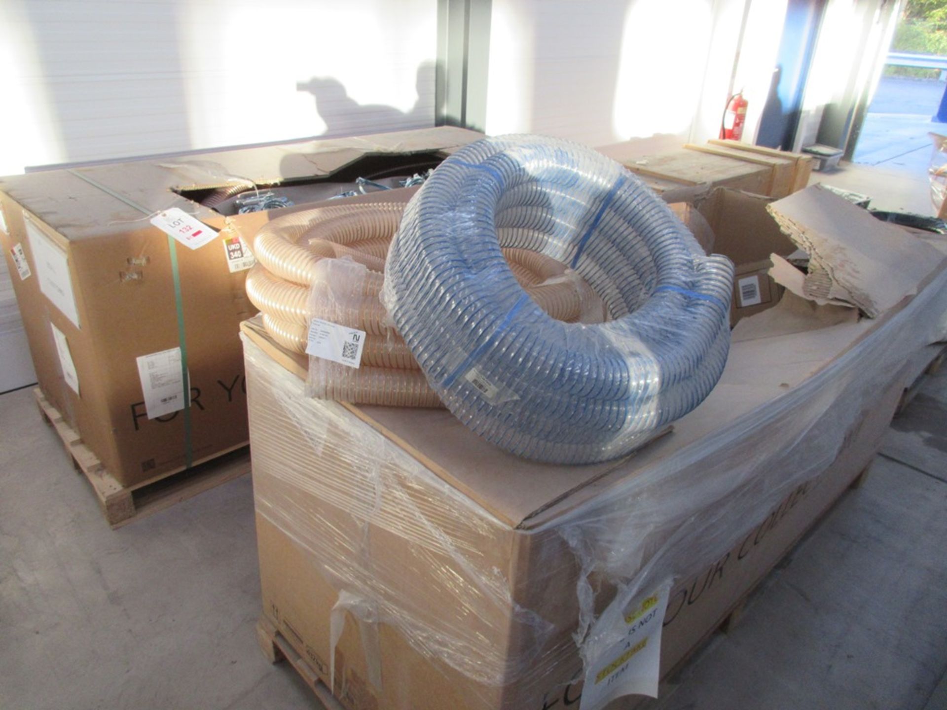 Two boxes of extraction hosing, steel pipe clips, ducting, etc.