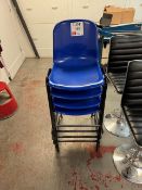 Four blue plastic tall stacking chairs