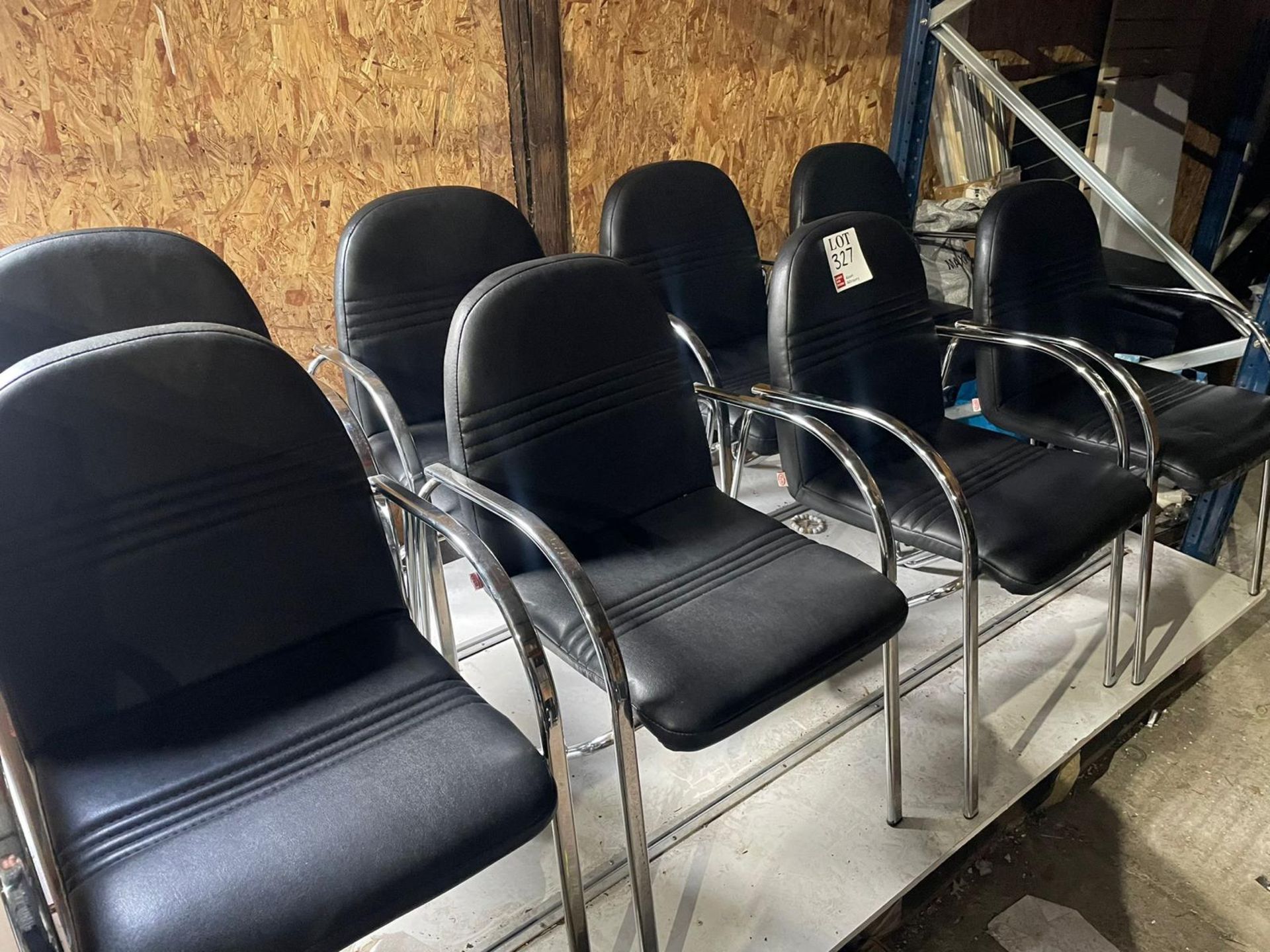 Eight black leather upholstered chairs with chrome frame