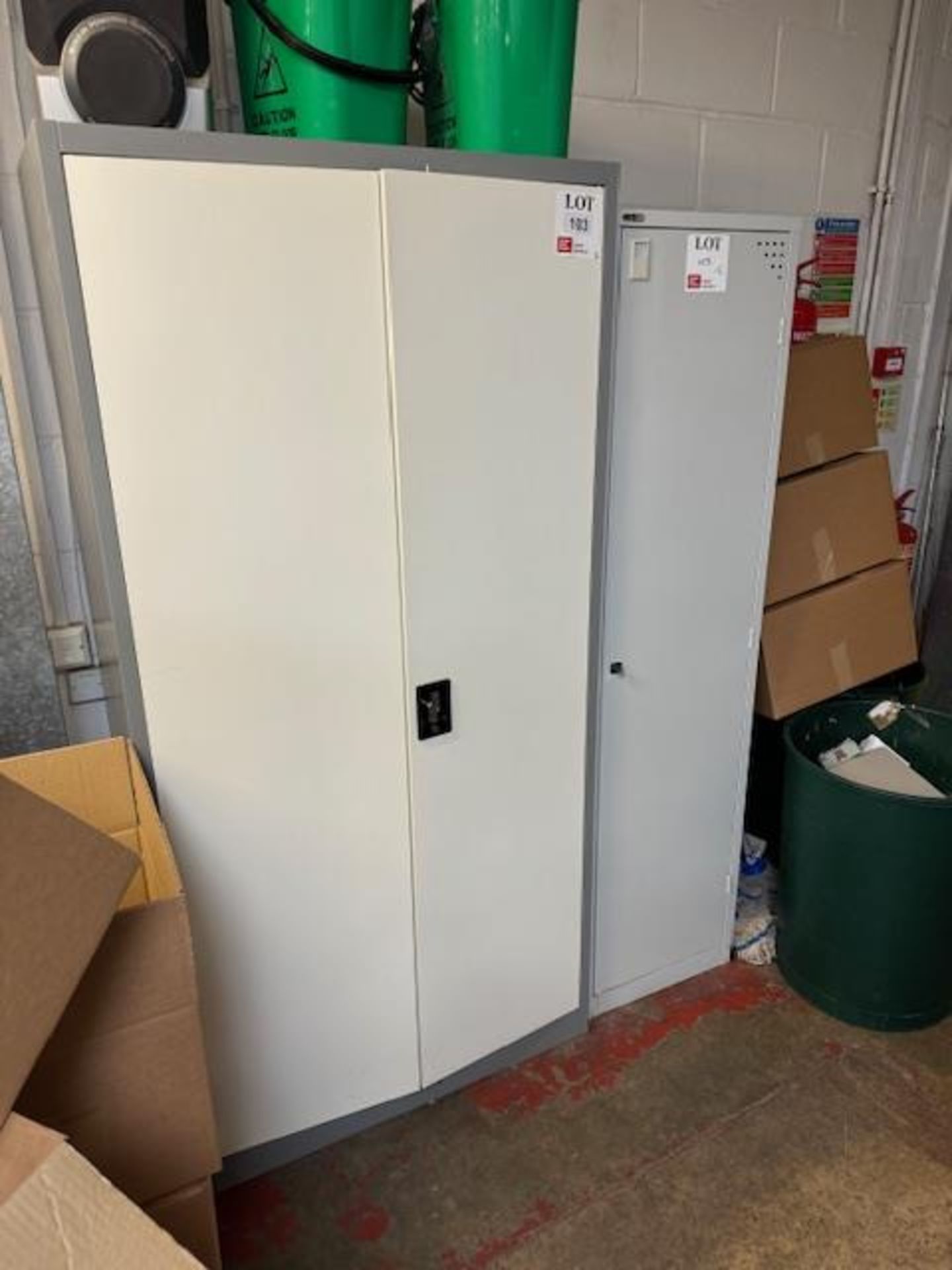 One double door and one single door metal cabinets with various cleaning products (as lotted)