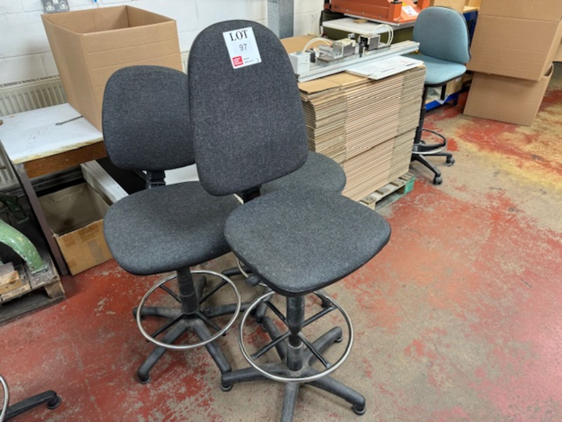 Three grey tall operator chairs