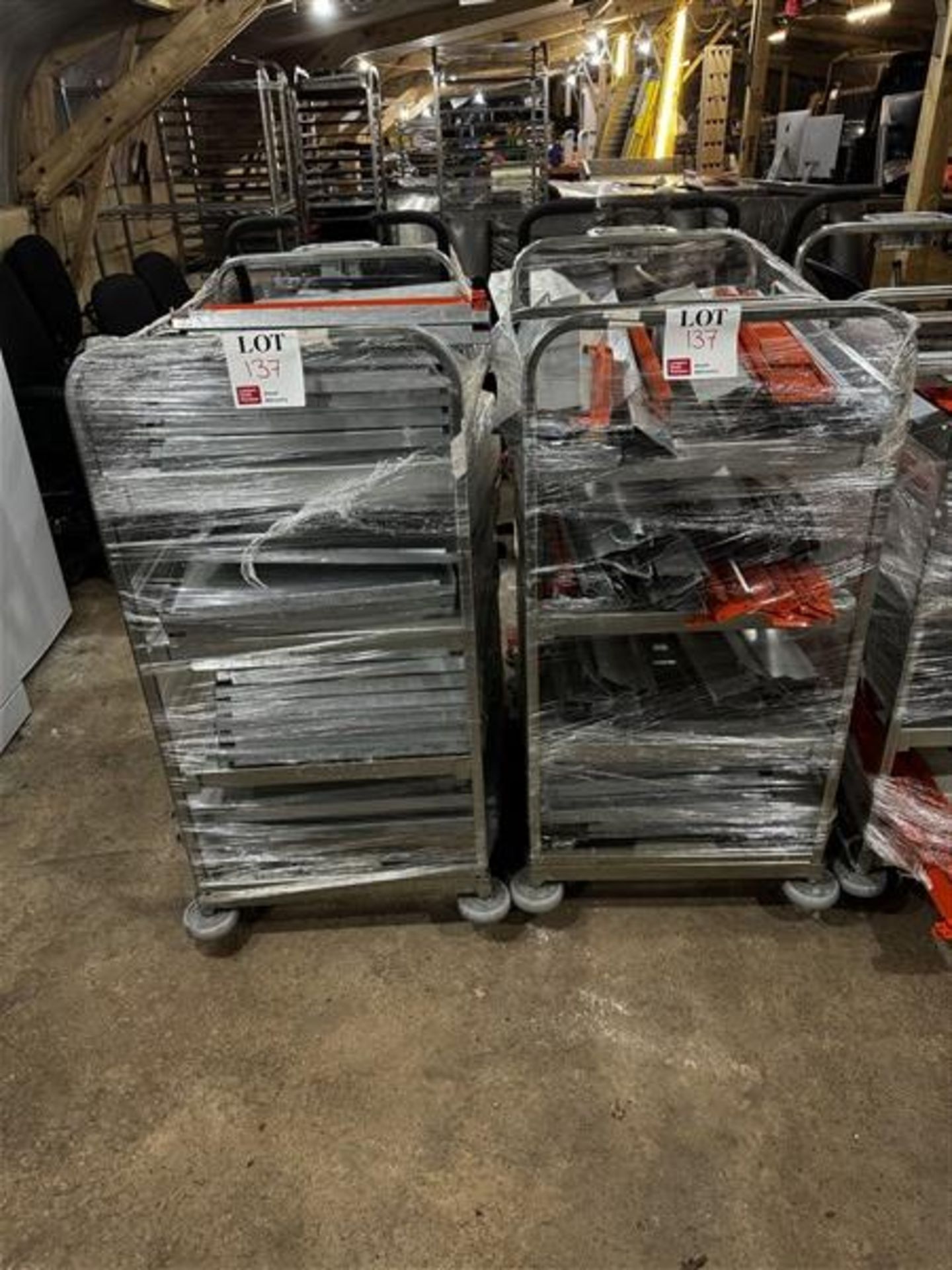 Two metal framed trolleys (excluding contents)