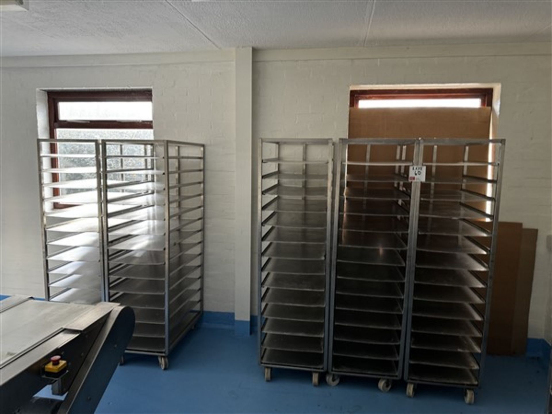 Five 14-shelf stainless steel trolleys with 20 spare shelves