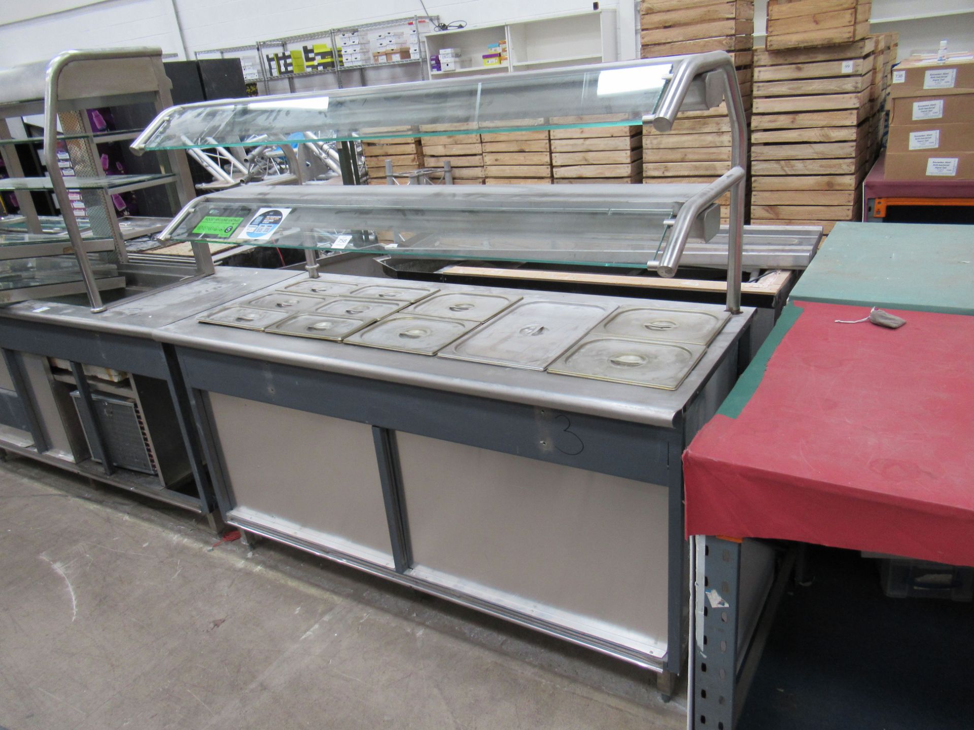 A stainless steel serving station, Bain Marie and hot cupboard with illuminated canopy