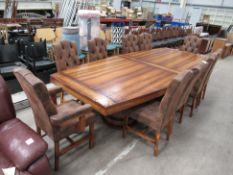 A Large Wood Effect Table together with Ten Distressed Effect Buttoned Back Dining Chairs