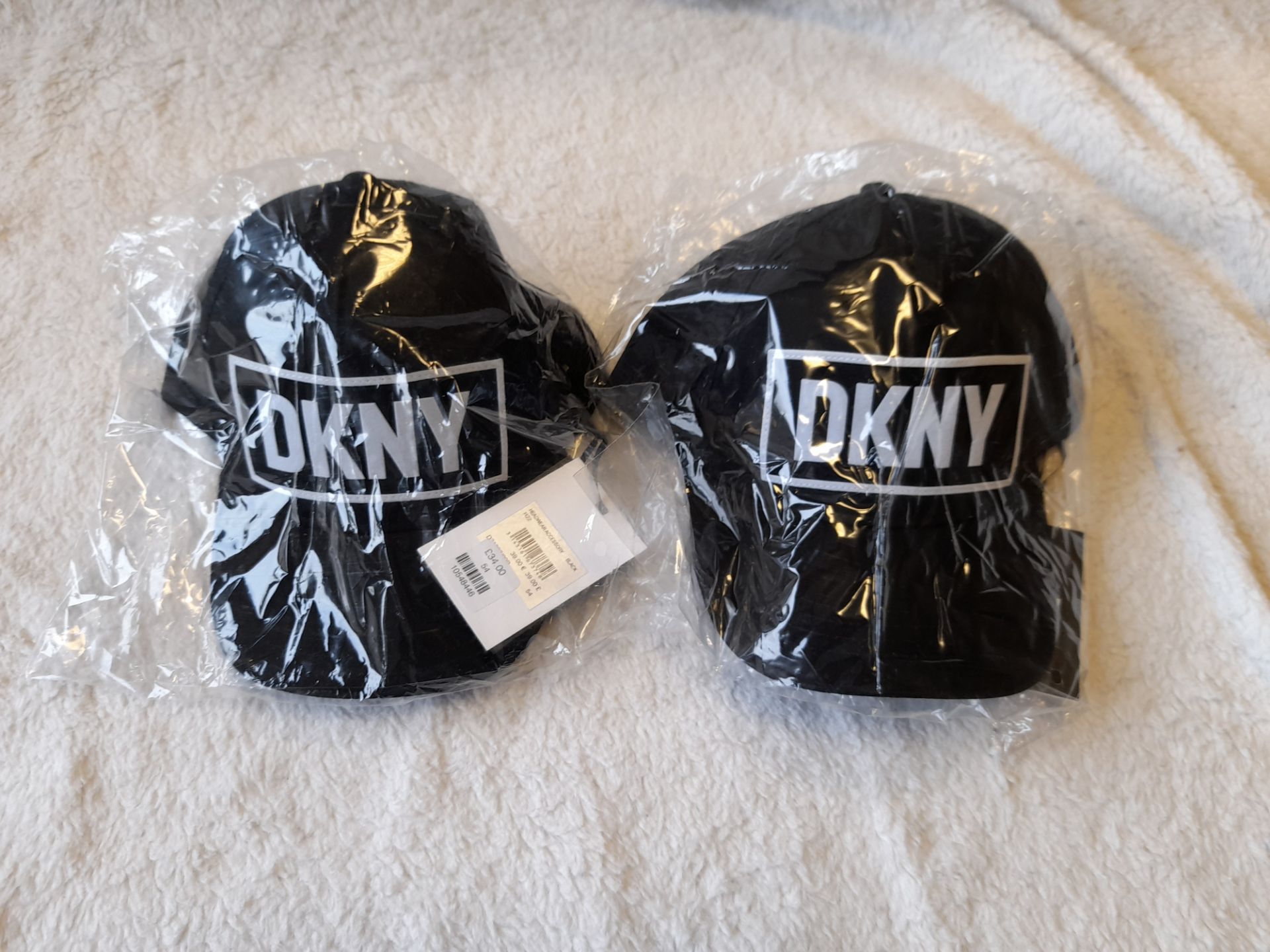 2 x DKNY black caps, RRP £34.00 each (total £68.00