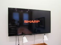 Sharp Aquos 60in wall mounted smart television with remote (EAT) ; Located: Fabric House, Holly Park