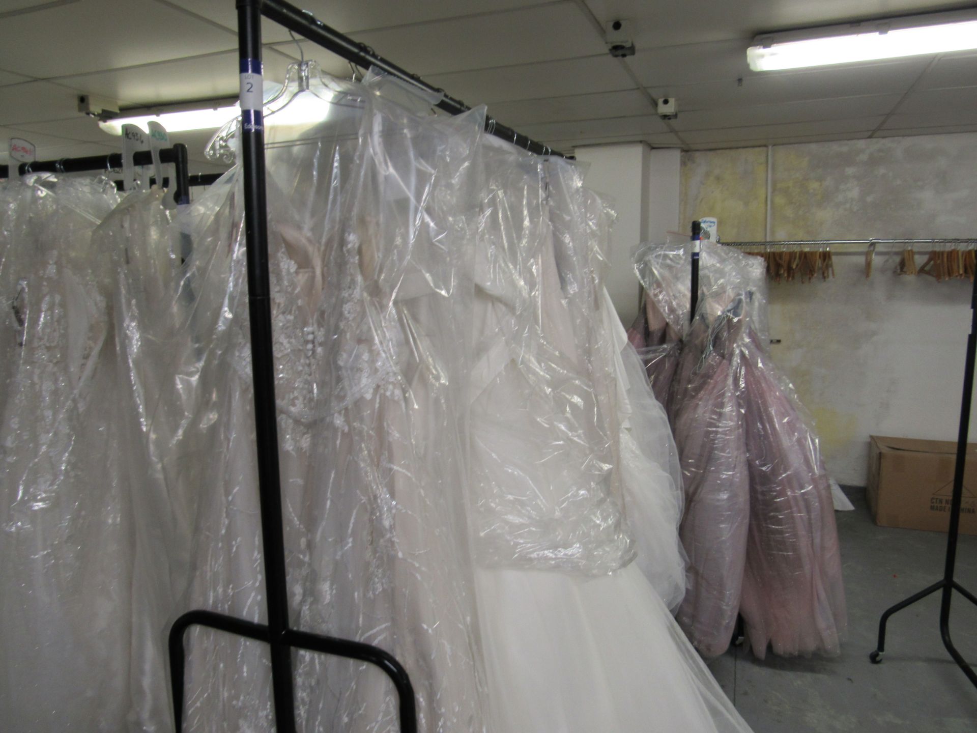 11 various bridal gowns and 2 dresses to rail