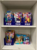 Contents of 2 shelves to include qty of various Pez candy dispensers