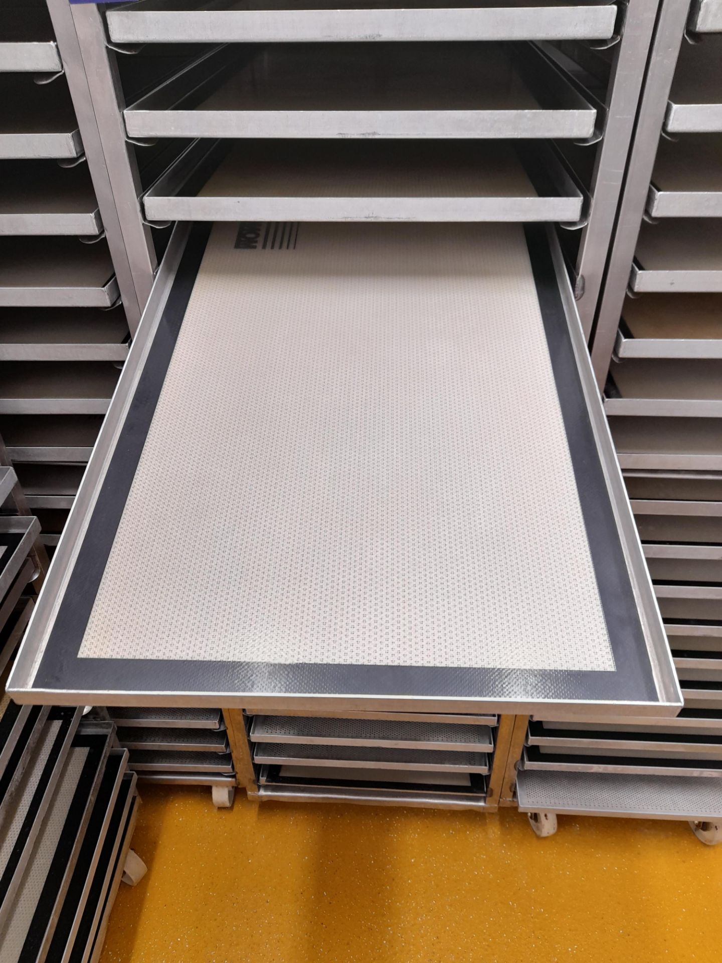 6 x Stainless steel mobile oven racks with 20 x stainless steel mono trays