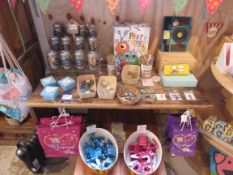 Quantity of money jars, badges and bags to table