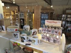 Quantity dog themed mugs and key rings to shelf