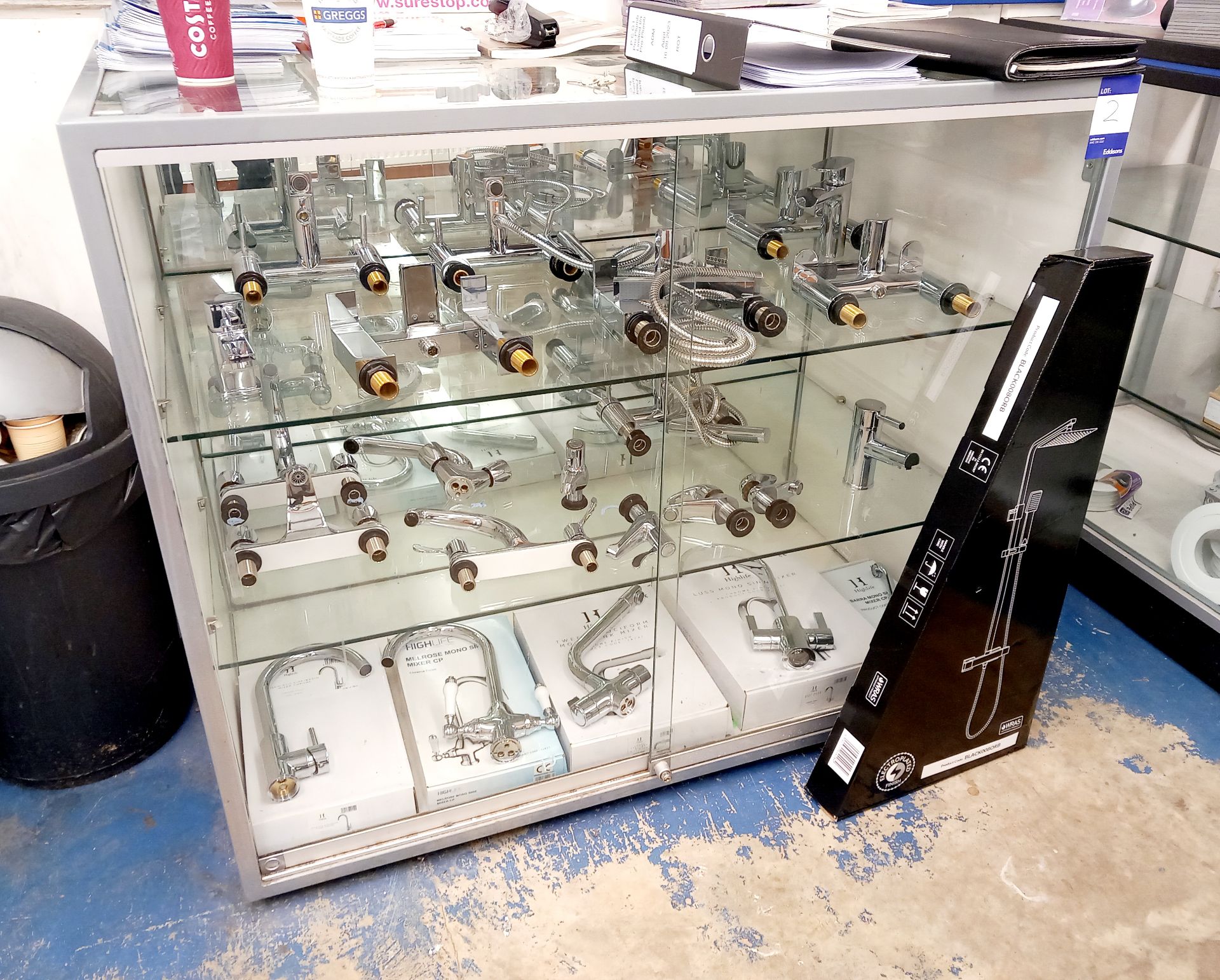 Approximately 20 x various chrome mixer taps to glass cabinet (included) with shower system. This